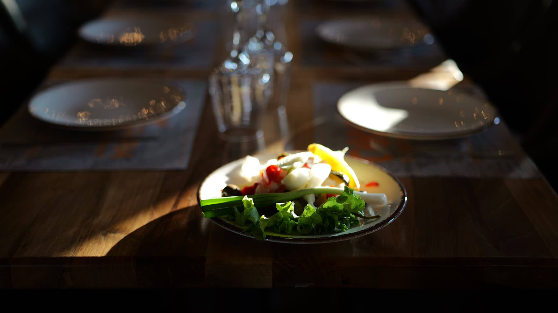 Fresh village salad with white cheese and greens in the afternoon light